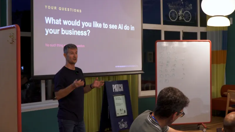 Christian Rodwell presenting at AI for Business Bournemouth, asking what the room would like to see AI do in their business