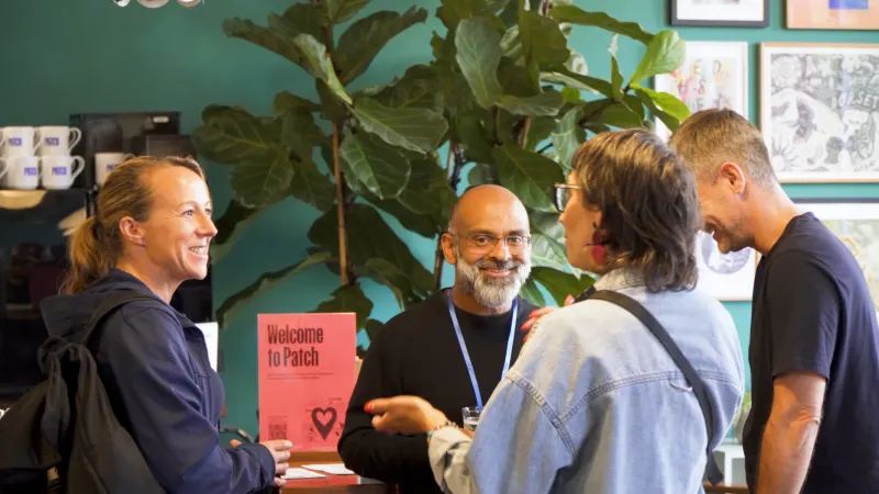 Owners networking by the Welcome to Patch sign at AI for Business Bournemouth